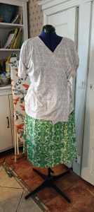 Green skirt and beige wrap blouse